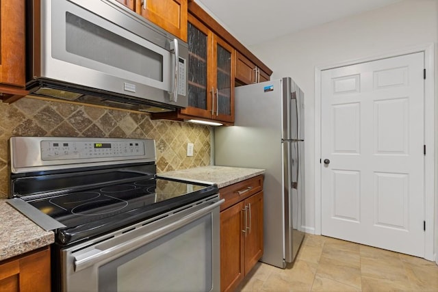 3334 Peachtree Rd NE Unit 101, Atlanta, GA 30326 - kitchen featuring stainless steel appliances and brown cabinetry