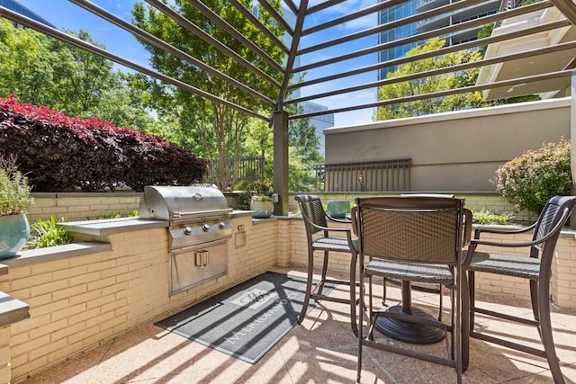 3334 Peachtree Rd NE Unit 101, Atlanta, GA 30326 - view of patio featuring outdoor dining area, a grill, exterior kitchen, a pergola, and fence