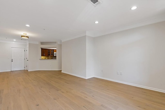 3334 Peachtree Rd NE Unit 101, Atlanta, GA 30326 - unfurnished living room with ornamental molding, recessed lighting, light wood-style flooring, and baseboards