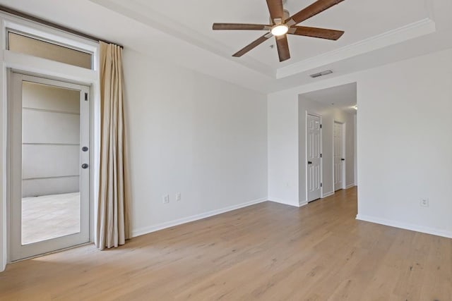 3334 Peachtree Rd NE Unit 101, Atlanta, GA 30326 - spare room with a raised ceiling, ceiling fan, light wood finished floors, baseboards, and crown molding