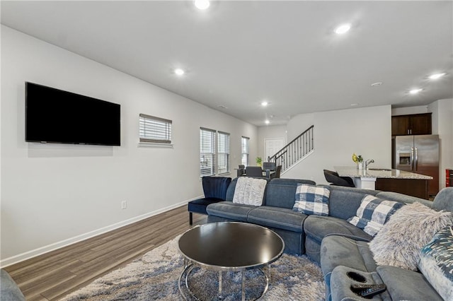 living room with sink and hardwood / wood-style floors