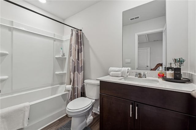 full bathroom with vanity, hardwood / wood-style flooring, toilet, and shower / bath combo with shower curtain