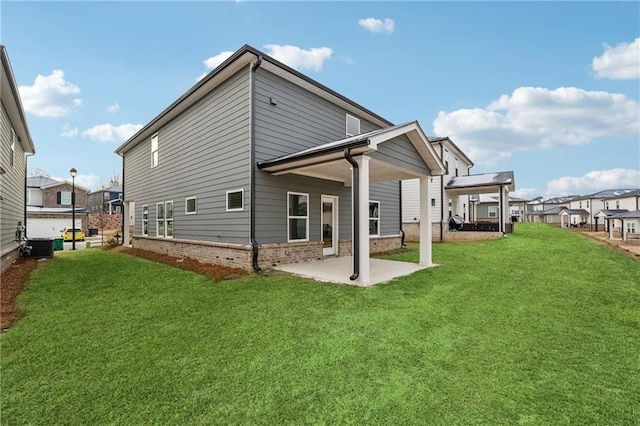 rear view of property featuring cooling unit, a patio, and a lawn