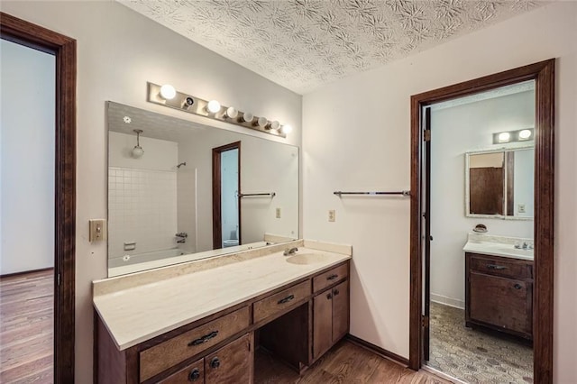 bathroom with vanity, hardwood / wood-style floors, and a textured ceiling