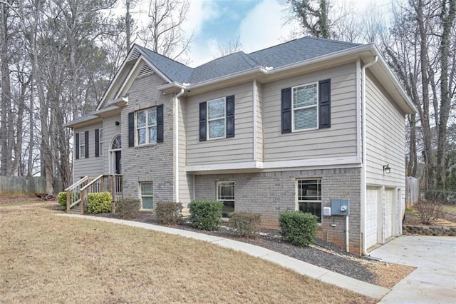 view of front of house featuring a garage and a front lawn