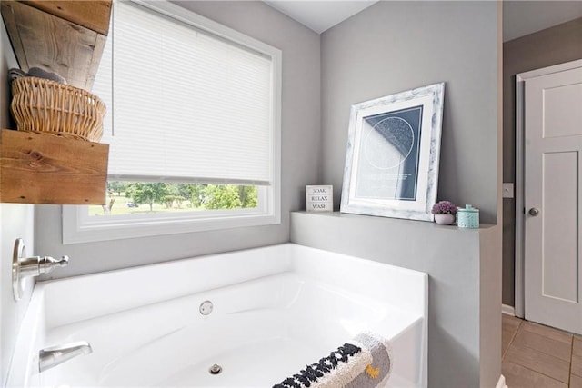 bathroom featuring a garden tub and tile patterned floors