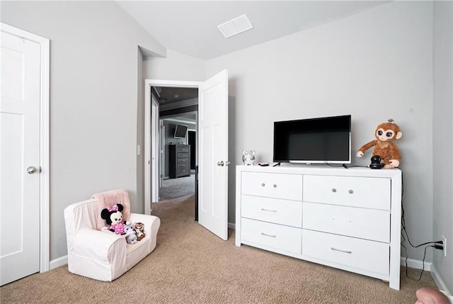 bedroom featuring light carpet and baseboards