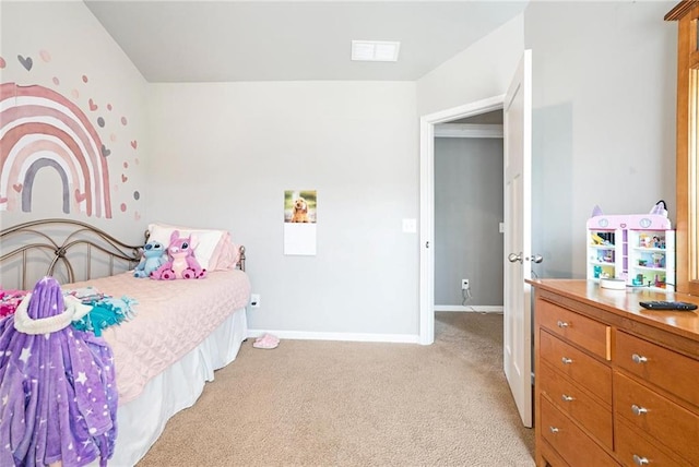 bedroom featuring light carpet and baseboards