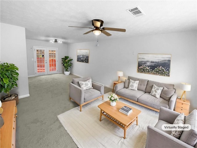 living area with french doors, visible vents, a ceiling fan, light carpet, and baseboards