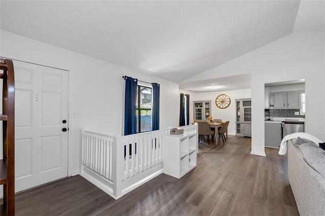 4771 N Springs Rd NW, Kennesaw, GA 30144 - foyer entrance featuring lofted ceiling, dark wood-style floors, and baseboards