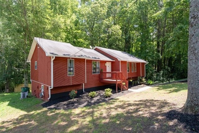 4771 N Springs Rd NW, Kennesaw, GA 30144 - view of front facade with a wooded view, a front yard, a wooden deck, and central AC