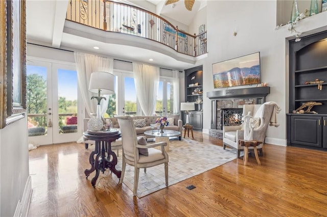 living room featuring a high ceiling, french doors, and wood-type flooring