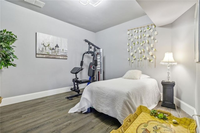 bedroom with hardwood / wood-style flooring