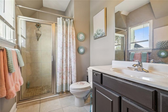 bathroom featuring toilet, vanity, tile patterned floors, and a shower with shower door