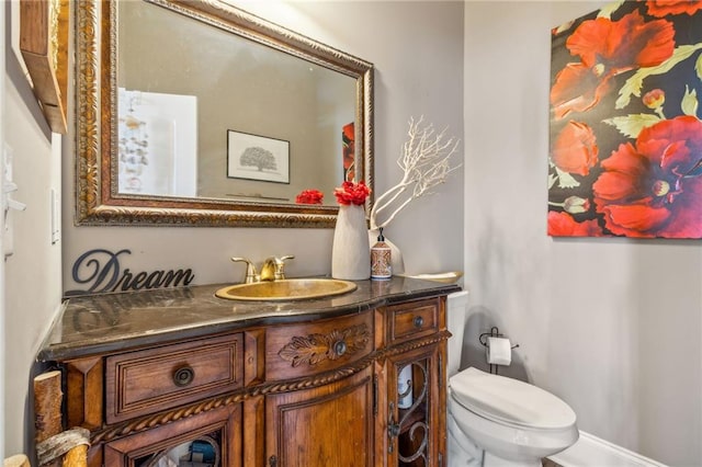 bathroom featuring toilet and vanity