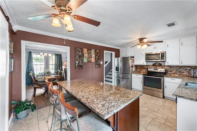 3778 Berdon Ln, Decatur, GA 30034 - kitchen with stainless steel appliances, ceiling fan, backsplash, dark stone countertops, and white cabinets
