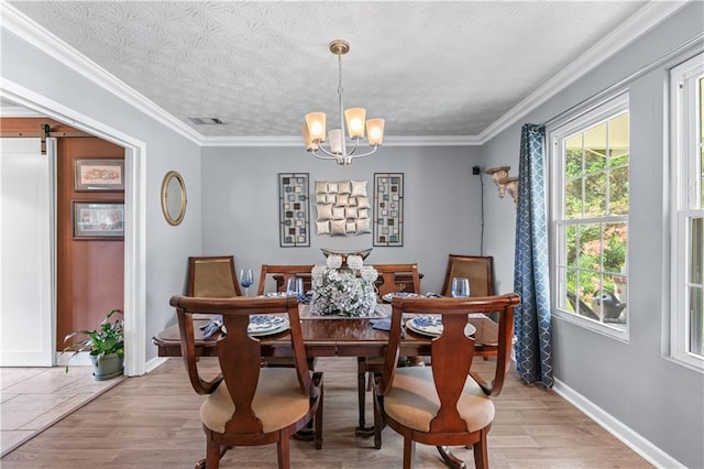 3778 Berdon Ln, Decatur, GA 30034 - dining area featuring a chandelier, baseboards, light wood-style flooring, ornamental molding, and a barn door