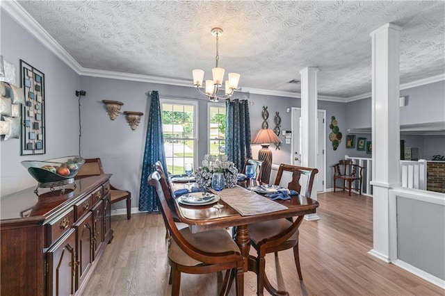 3778 Berdon Ln, Decatur, GA 30034 - dining area with ornate columns, light wood-style floors, a chandelier, ornamental molding, and baseboards