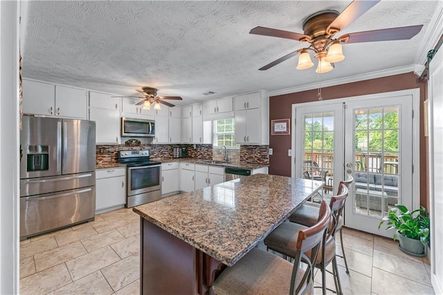 3778 Berdon Ln, Decatur, GA 30034 - kitchen with stainless steel appliances, ceiling fan, a sink, tasteful backsplash, and white cabinets