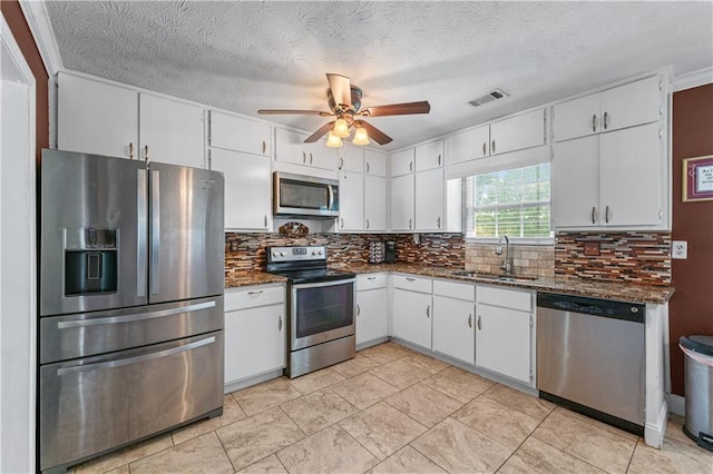 3778 Berdon Ln, Decatur, GA 30034 - kitchen featuring appliances with stainless steel finishes, a sink, ceiling fan, white cabinetry, and tasteful backsplash