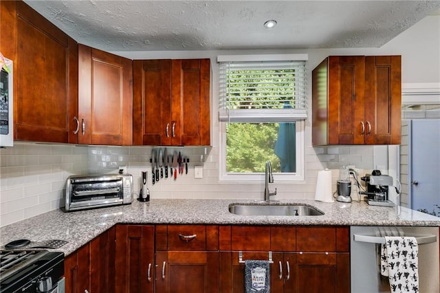 kitchen featuring a toaster, tasteful backsplash, light stone counters, a sink, and dishwasher