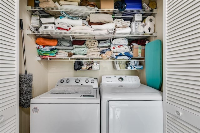 clothes washing area with laundry area and washing machine and clothes dryer