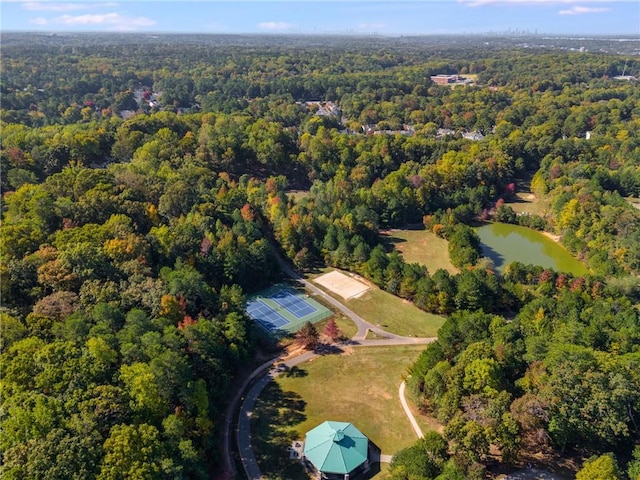 drone / aerial view featuring a view of trees and a water view