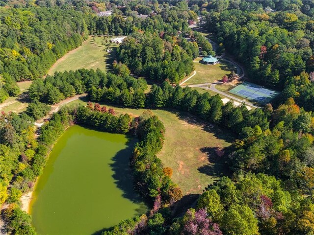 aerial view with a water view and a wooded view