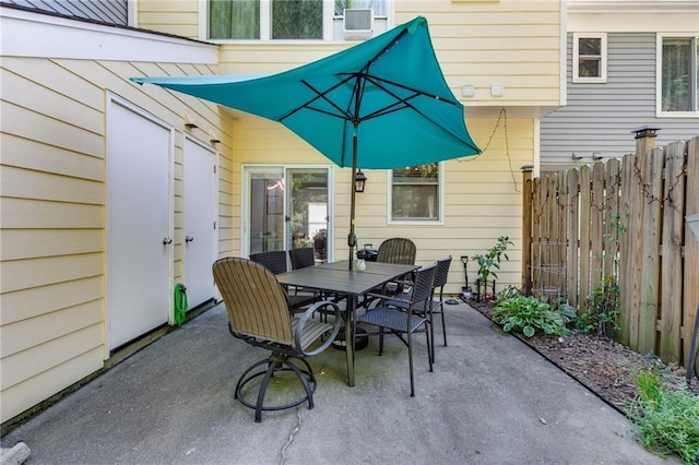 view of patio featuring fence and outdoor dining space