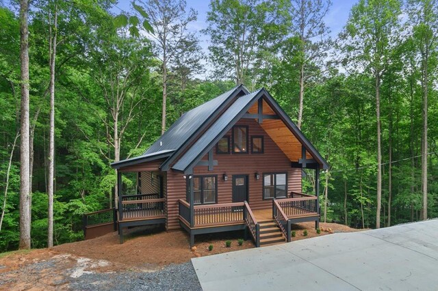 log-style house with covered porch