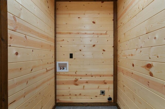 laundry area with wooden walls, electric dryer hookup, and washer hookup