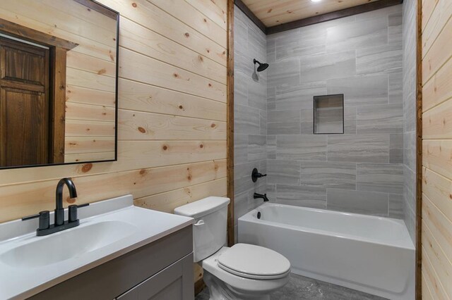 full bathroom with wooden ceiling, oversized vanity, wood walls, tiled shower / bath combo, and toilet