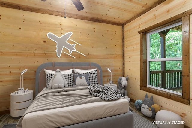 bedroom featuring wooden walls, ceiling fan, hardwood / wood-style flooring, and wood ceiling