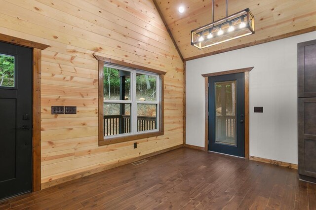 entryway with a healthy amount of sunlight, dark hardwood / wood-style floors, wood ceiling, and wood walls