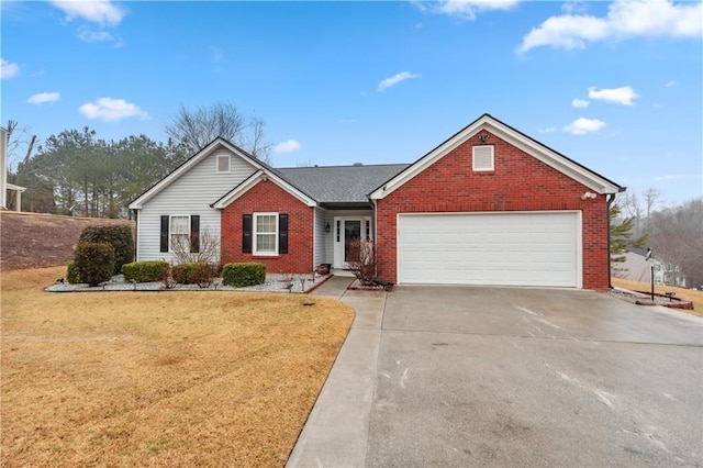 ranch-style home featuring brick siding, a garage, driveway, and a front yard