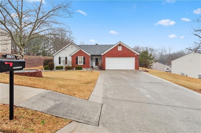 view of front of house with brick siding, a garage, concrete driveway, and a front lawn