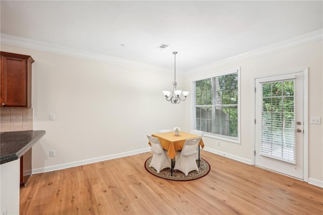 718 Surrey Park Pl SE, Smyrna, GA 30082 - unfurnished dining area with a notable chandelier, crown molding, and light hardwood / wood-style floors