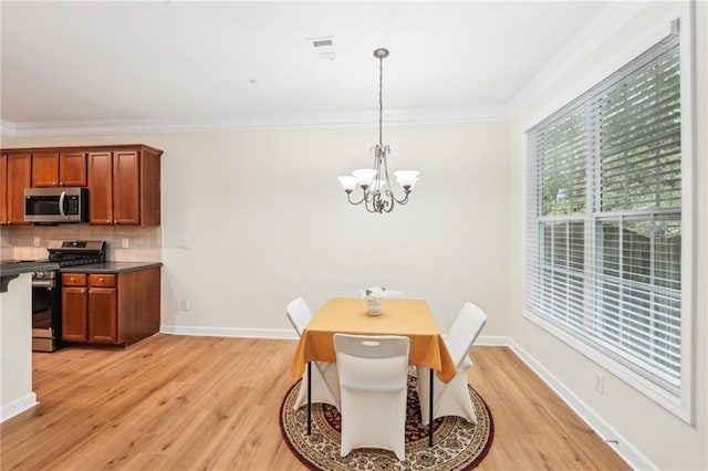 718 Surrey Park Pl SE, Smyrna, GA 30082 - dining room with crown molding, light hardwood / wood-style floors, and a chandelier