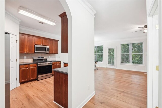 718 Surrey Park Pl SE, Smyrna, GA 30082 - kitchen featuring stainless steel appliances, ornamental molding, tasteful backsplash, and light hardwood / wood-style floors