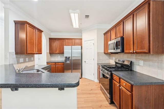 718 Surrey Park Pl SE, Smyrna, GA 30082 - kitchen featuring appliances with stainless steel finishes, a breakfast bar, sink, and kitchen peninsula