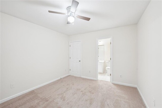 718 Surrey Park Pl SE, Smyrna, GA 30082 - unfurnished bedroom with connected bathroom, light carpet, and ceiling fan