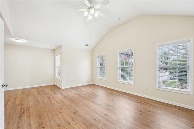 718 Surrey Park Pl SE, Smyrna, GA 30082 - spare room featuring lofted ceiling, plenty of natural light, ceiling fan, and light wood-type flooring