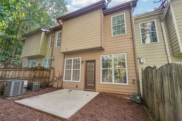 718 Surrey Park Pl SE, Smyrna, GA 30082 - back of house with central AC unit and a patio area