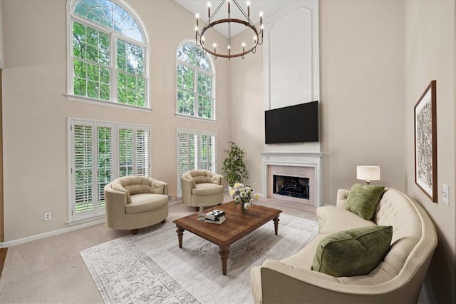 740 Orchard Ct, Atlanta, GA 30328 - living area with a high ceiling, a chandelier, a fireplace, and light carpet