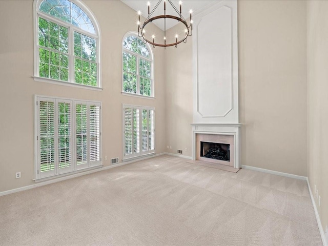 740 Orchard Ct, Atlanta, GA 30328 - unfurnished living room with a chandelier, light carpet, a high ceiling, and a fireplace