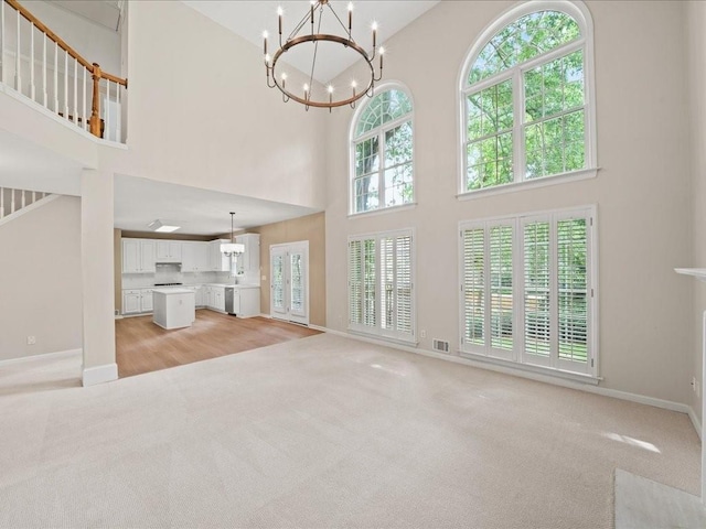 740 Orchard Ct, Atlanta, GA 30328 - unfurnished living room featuring a high ceiling, light colored carpet, and a chandelier