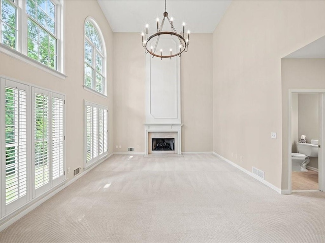 740 Orchard Ct, Atlanta, GA 30328 - unfurnished living room featuring a chandelier, high vaulted ceiling, light carpet, and a fireplace