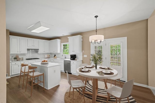 740 Orchard Ct, Atlanta, GA 30328 - kitchen with dishwasher, a kitchen island, white cabinets, dark wood finished floors, and light countertops