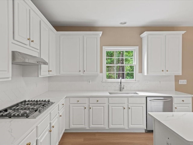 740 Orchard Ct, Atlanta, GA 30328 - kitchen with appliances with stainless steel finishes, white cabinets, range hood, tasteful backsplash, and light wood-type flooring