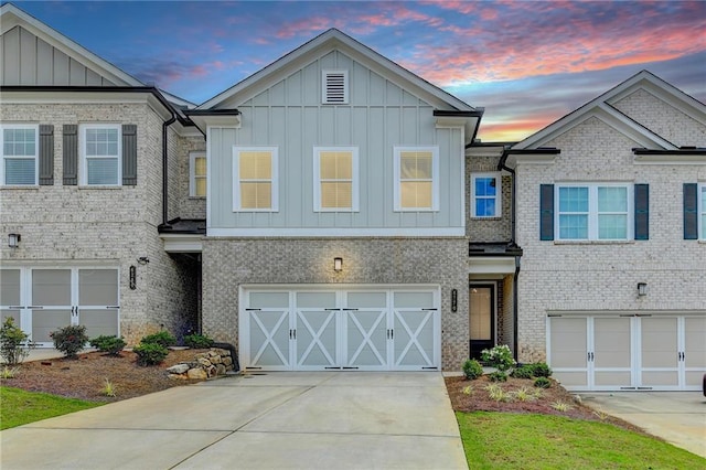 6270 Bracken Brown Dr, Alpharetta, GA 30004 - view of front of property with an attached garage, board and batten siding, driveway, and brick siding